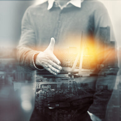 Business person, overlay and man with handshake, city and partnership with thank you. Hello, double exposure and employee with gesture, cooperation and collaboration with team building and welcome.