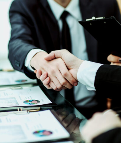 handshake business partners after discussion of the financial agreement closeup of handshake of business partners after discussion of the financial agreement on the background of the workplace